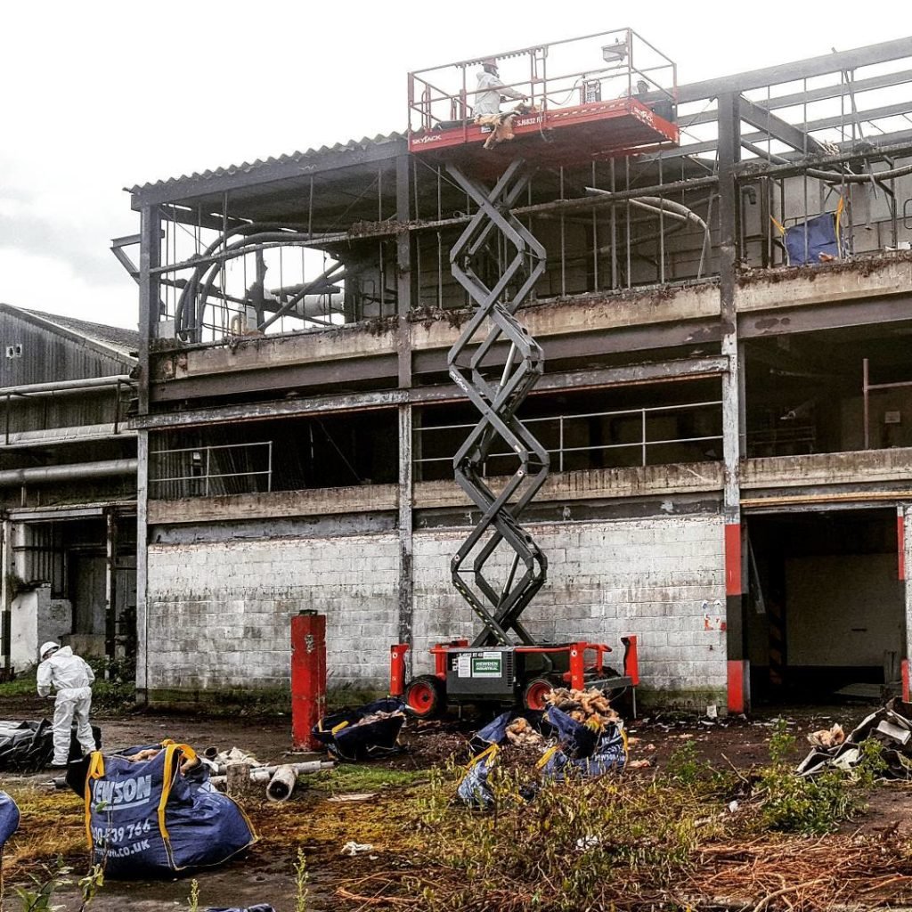Partly dismantled commercial building in Cleethorpes with a scissor lift