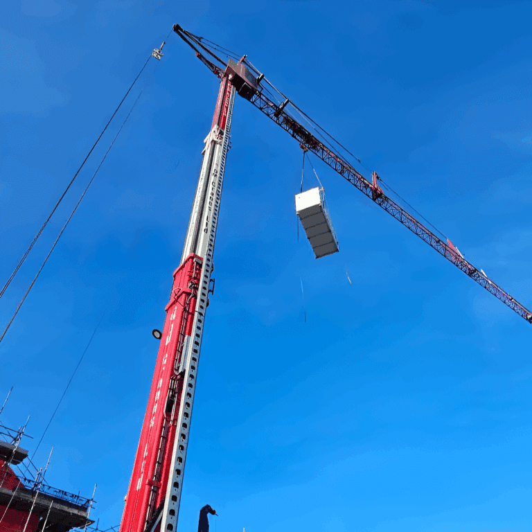 AHU lifted towards the rooftop plantroom by a 60m mobile tower crane