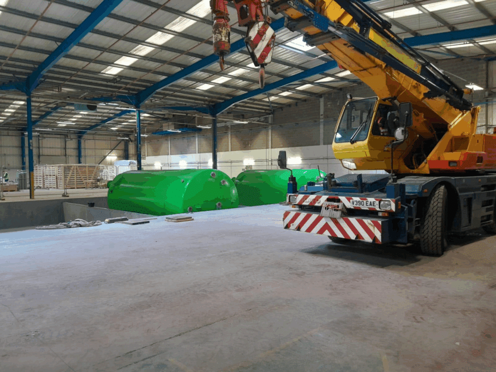 Electric pick and carry crane beside tanks inside the factory