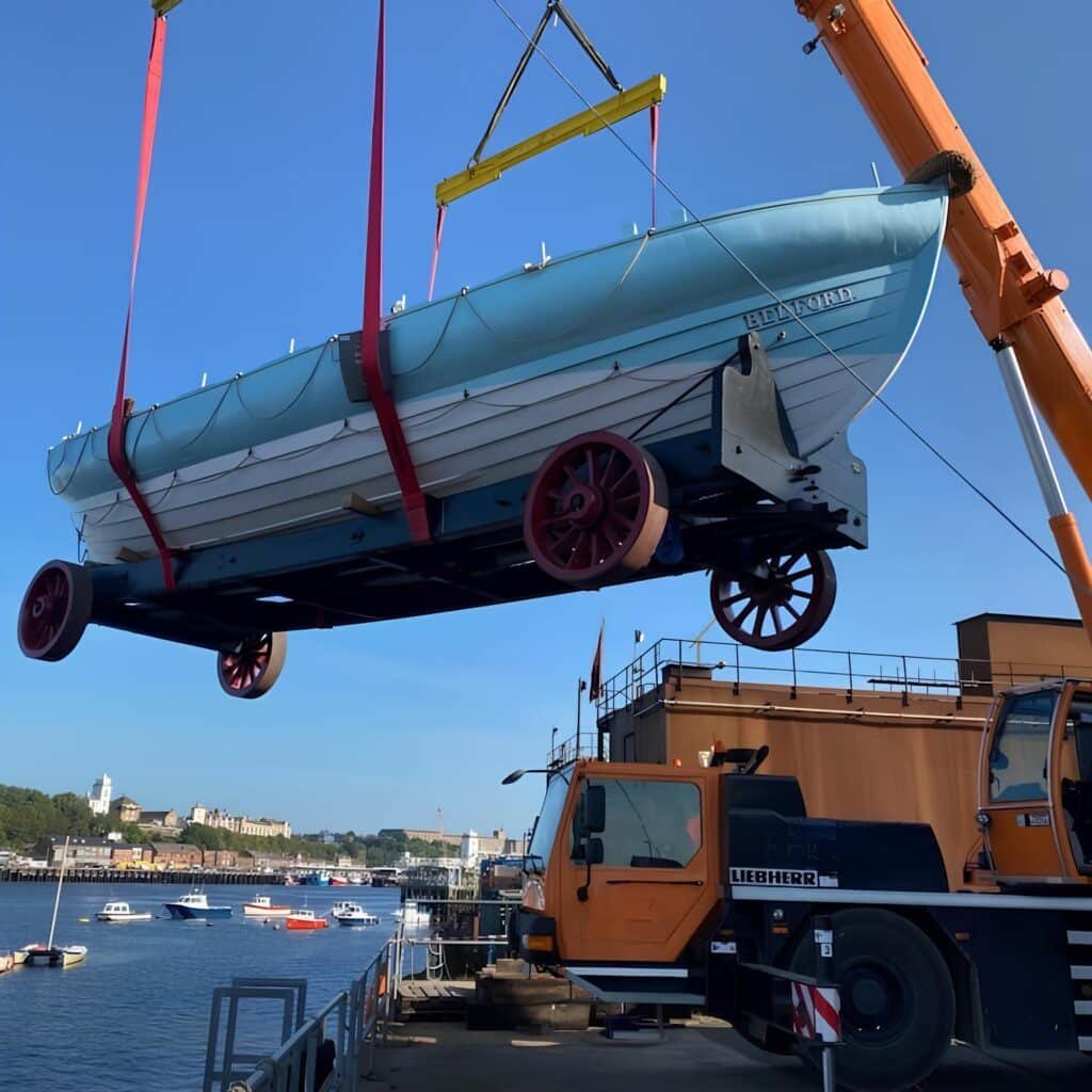The Bedford lifeboat and her carriage lifted from transport by a mobile crane in South Shields