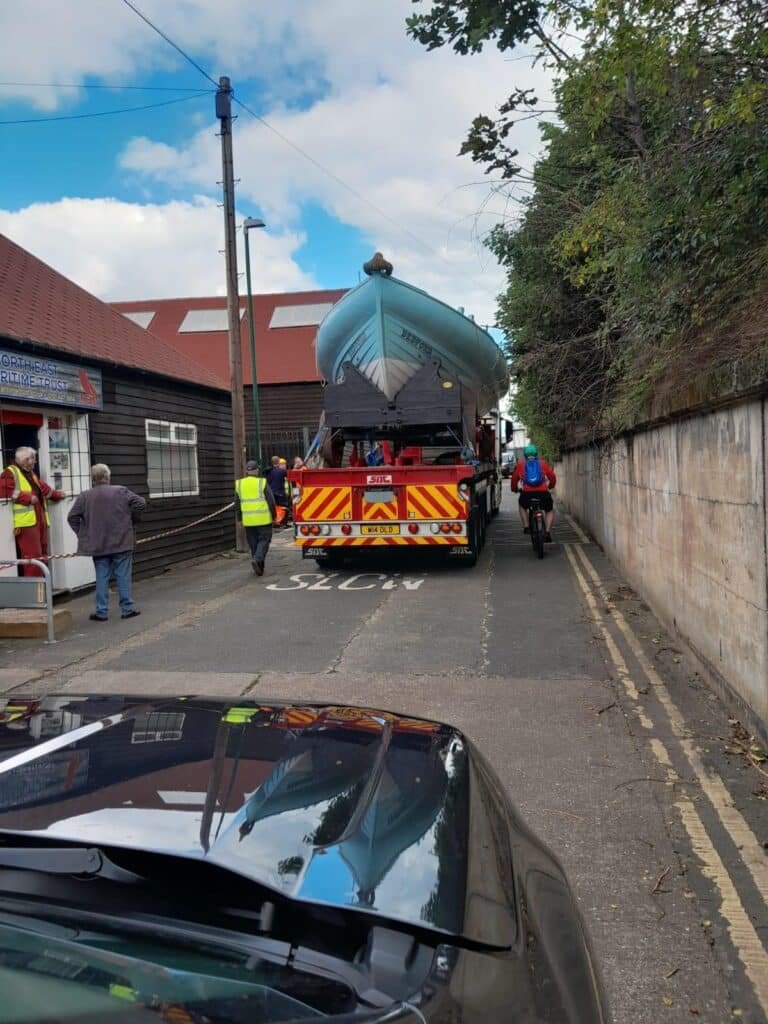 The Bedford on transport in the narrow street outside the restoration workshop