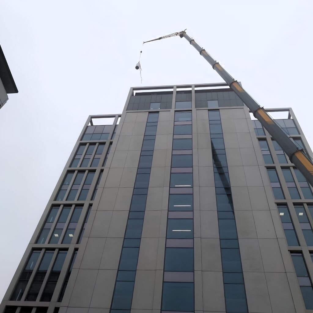 230te crane with an offset fly jib reaching the roof of a 64m building in Newcastle