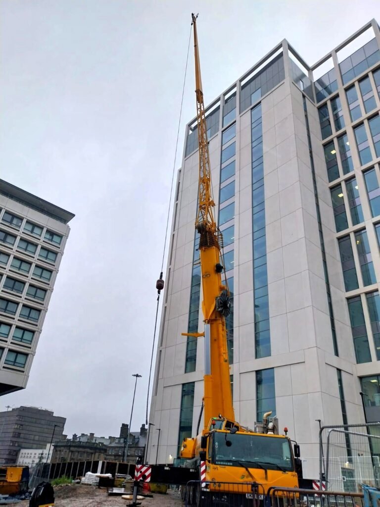 230te all-terrain crane set up at the base of a 64m building in Newcastle