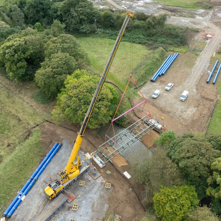 Drone view of a 250te crane lifting a 24te pipe bridge over Alwent Beck
