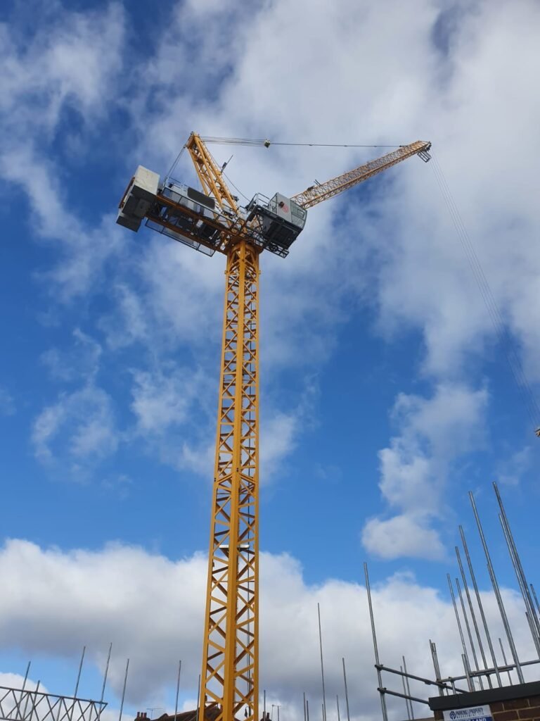 A Jaso J80PA tower crane standing over the steel frame at Lampton Road, Hounslow, with a red aircraft warning light on the jib